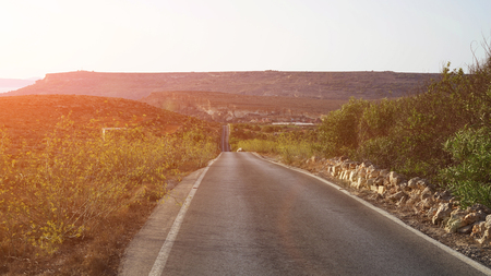 The scenic road with views of the mountains at sunsetの写真素材