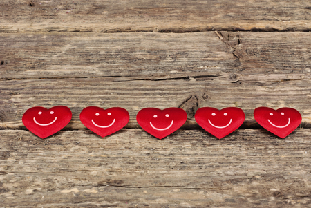 Valentines day red hearts on old wooden background. Greeting card with copy spaceの写真素材