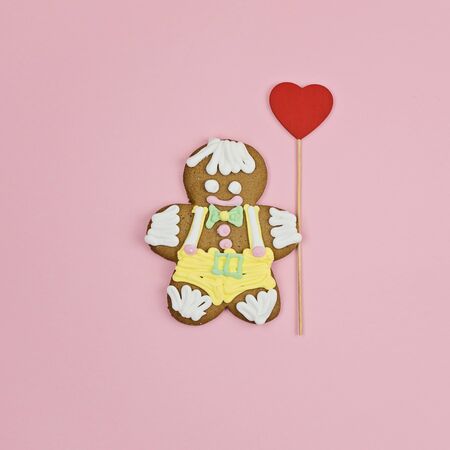 Large gingerbread man cookie with big red heart, Valentines day greeting card concept