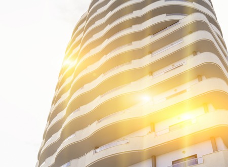 Abstract fragment of modern building with sunbeam and glare effect, toned, copy space