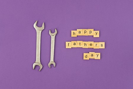 Two wrench large and small and text Happy Fathers Day. Greeting card to celebrate Fathers day, copy...