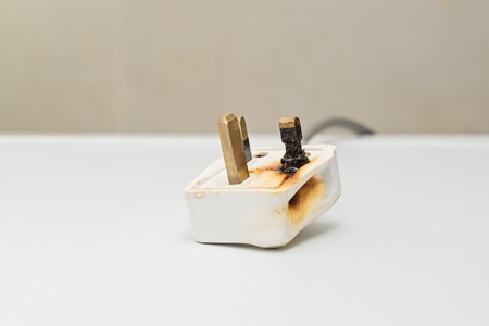 Burned 250V uk style socket and converter. Improper use of AC Power Plugs and Sockets cause of short...