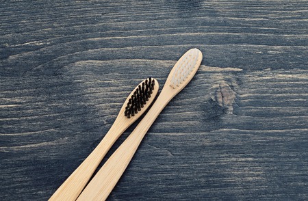 Wooden toothbrushes for the care of teeth. Respect for the environment and reduce the use of plastic in life concept. flat lay copy spaceの写真素材