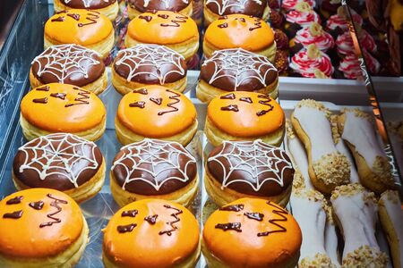 Freshly baked muffins and cupcake decorated with skulls and ghosts for Halloween. Sweet Treats for Halloween Celebrations for kidsの写真素材