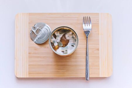 Open tin can with beans covered in blue mold. Improper food storage. Unhealthy foods, top view