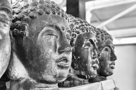 Closeup cement Buddha head. Modern Art concept. Black and white photography, soft focusの写真素材