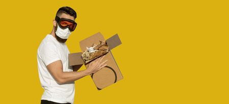 Unboxing of an infected postal package. Man in protective goggles and surgical mask unpacking...