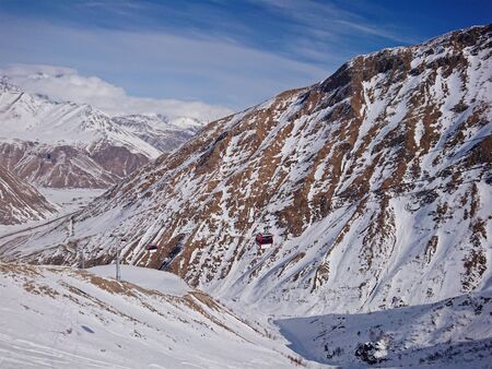 Stunning view of mountain ranges in snow and cable car in the snow resort of Gudauri in Georgia