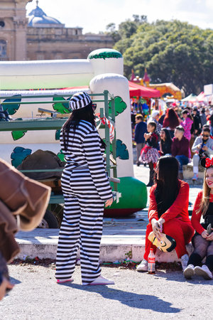 People in makeup and carnival costumes during Fat Tuesday at Mardi Gras carnival in Valletta, Maltaのeditorial素材