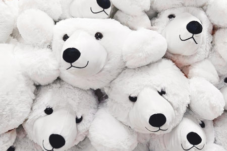 Fuzzy and fluffy cozy soft toy white polar bears closeup, full-frame backgroundの写真素材