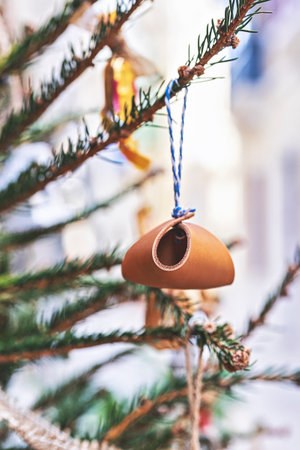 Closeup leather toy on Christmas tree branch. handmade Christmas zero-waste ornaments.の写真素材
