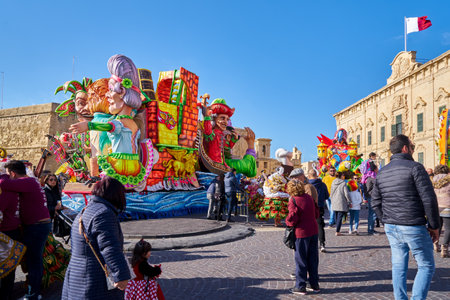 Annual Mardi Gras Fat Tuesday grand parade on maltese street of allegorical floats and masquerader...
