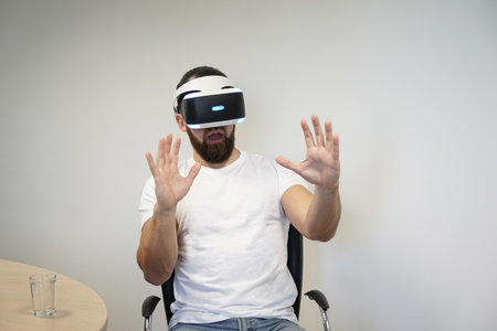 Man using hand gestures to interact with virtual environment while wearing VR headset