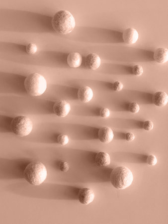 Abstract Wool Balls Arranged on Soft Pastel Background with Copy Space toned in color of year 2025の写真素材