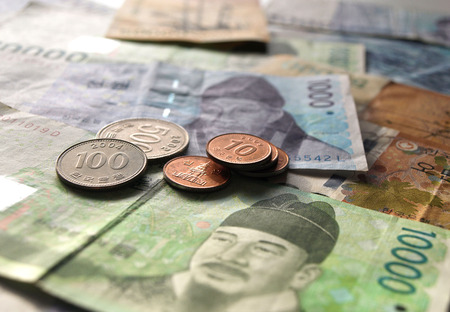 Korean won coin on banknote asian currency business finance conceptの写真素材