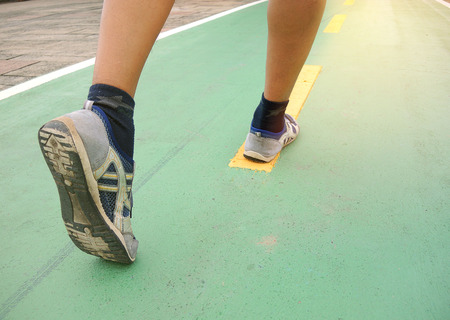 Man running outdoors on a sunny day. Man fitness jog workout wellness concept.
