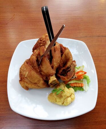 German Pork Hocks - Deep fried pork knuckle served with mashed potatoes.の写真素材