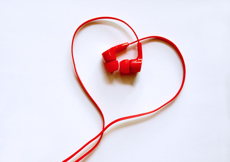 Headphones earphones red heart shape on white background /  Love musicの写真素材