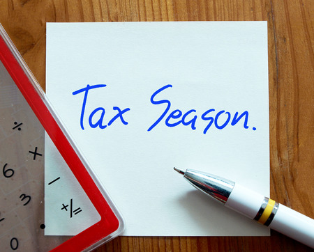 Tax Season written on paper note with pen and calculator - Business concept.の写真素材
