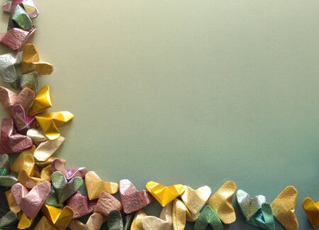 Valentines Day paper hearts forming a bottom corner border over vintage backgroundの写真素材