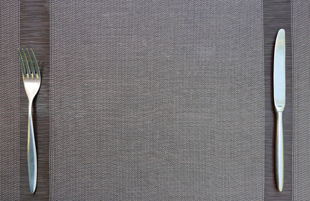 Fork and knife on tablecloth background with copy space design for food drink concept.の写真素材