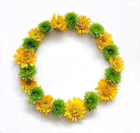 Flower composition round frame wreath made of various yellow and green flowers on white background.  Flat lay, top viewの写真素材