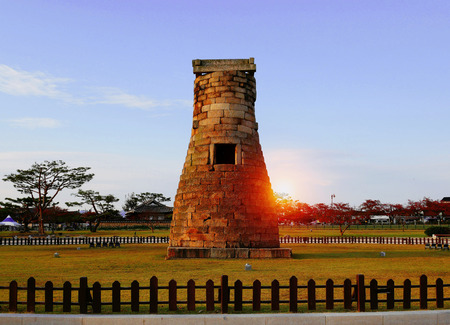 The sunset behind Cheomseongdae observatory in Gyeongju, South, Korea. Cheomseongdae is the oldest astronomical observatory in South Korea.の写真素材