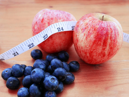 Apple and blueberry with measuring tape concept of healthy diet.の写真素材