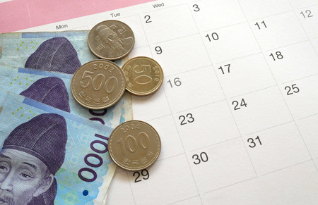 South Korean won currency on calendar background. Financial saving plan concept.の写真素材