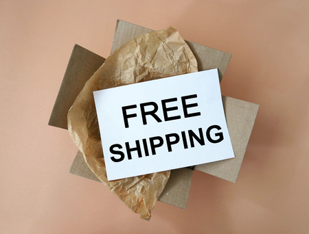 Cardboard package box with Free Shipping text, delivery commercial business concept.の写真素材