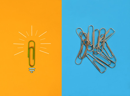 Individual paperclip standing out of the crowd. Creative idea and difference concept.