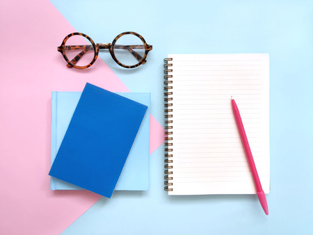 Creative workplace on pink and blue background.の写真素材