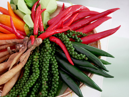 Fresh herbs and spices for asian cooking : chilli, pepper and finger root and kaffir lime leaf.の写真素材