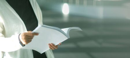 Woman reading opened book. Copy space. Lifestyle and school concept.の写真素材