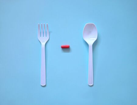 Medicine capsules served as a healthy meal. Take medicine instead of food. Healthy eating concept.