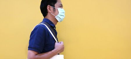 Asian man wearing medical masks to prevent disease, flu, air pollution, contaminated air, world pollution.の写真素材