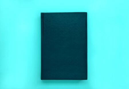 Minimal black leather book cover mock up on blue background.の写真素材