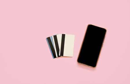 Credit card and smart phone on pink background. Online shopping concept.の写真素材