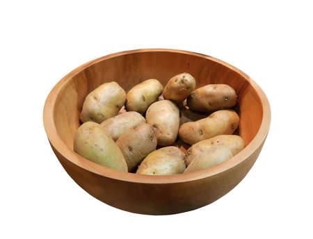Fresh potatoes in wooden bowl isolated on white background.の写真素材