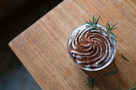 Banoffee with white cream and chocolate powder on wood table background, top viewの写真素材