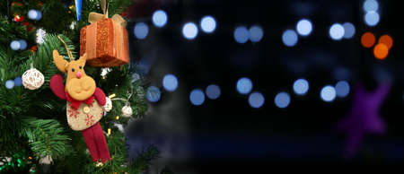 Christmas tree with decorations and gift on blurred background.の写真素材