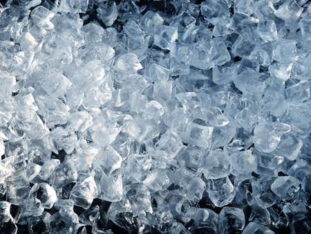 Crushed ice cubes on black background.の写真素材