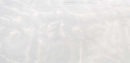 Light gray rough grainy concrete wall texture backgroundの写真素材