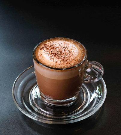 Cup of hot chocolate with cocoa powder on dark backgroundの写真素材