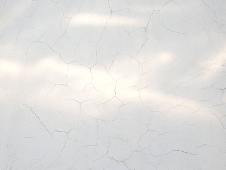 Natural light on white cracked weathered concrete wall texture background.の写真素材