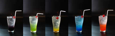Set of fresh summer cocktail with straws and ice cubes. Glass of cocktail soda drink on dark background.の写真素材