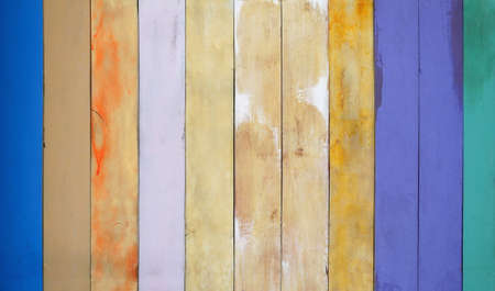 Vintage colored wood background. Old weathered wooden plank painted in colorful.の写真素材