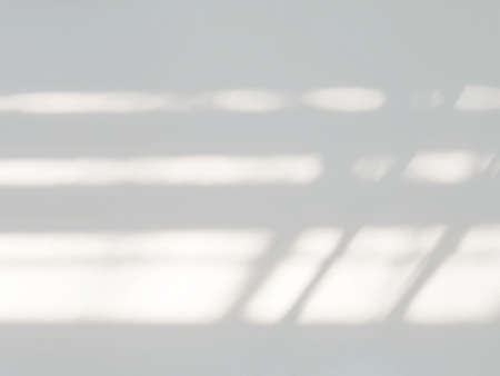 Gray cement wall texture background with light and shadow from window