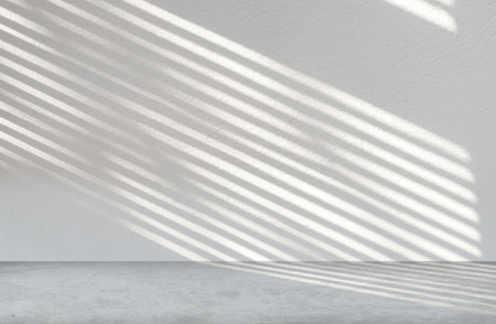 Gray cement wall texture background in empty room with light and shadow for product presentation.の写真素材