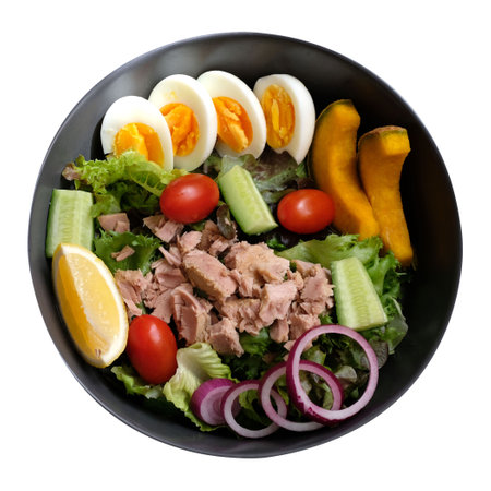 Tuna salad with eggs, tomatoes, pumpkins, lettuce, cucumber and onion isolated on white backgroundの写真素材